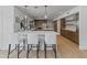 Bright kitchen featuring wooden cabinets, stainless steel appliances, and a counter with white cushioned chairs at 5711 E Corrine Dr, Scottsdale, AZ 85254