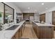 Spacious kitchen featuring stainless steel appliances, wood cabinets, and an island with a marble countertop at 5711 E Corrine Dr, Scottsdale, AZ 85254
