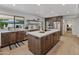 Bright kitchen featuring wooden cabinets, stainless steel appliances, an island with a smooth countertop, and natural light at 5711 E Corrine Dr, Scottsdale, AZ 85254