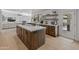 Modern kitchen with a spacious island, ample storage, and backyard views at 5711 E Corrine Dr, Scottsdale, AZ 85254