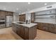 Bright kitchen featuring wooden cabinets, stainless steel appliances, an island with a smooth countertop at 5711 E Corrine Dr, Scottsdale, AZ 85254
