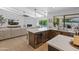 Open-concept kitchen with modern appliances, a wine fridge, and backyard views at 5711 E Corrine Dr, Scottsdale, AZ 85254