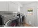 Well-lit laundry room featuring modern LG washer and dryer set and ample cabinet space for storage solutions at 5711 E Corrine Dr, Scottsdale, AZ 85254