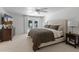 Serene main bedroom boasts a plush bed, a ceiling fan, and direct access to the pool area for relaxation at 5711 E Corrine Dr, Scottsdale, AZ 85254