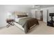 A bright and airy main bedroom features a ceiling fan, large windows, and a cozy, carpeted floor at 5711 E Corrine Dr, Scottsdale, AZ 85254