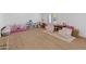 Bright playroom offers ample space for to play, features plush chairs, and plenty of natural light at 5711 E Corrine Dr, Scottsdale, AZ 85254