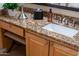 Close-up of a bathroom vanity featuring granite countertops and light wood cabinetry at 6135 E Campo Bello Dr, Scottsdale, AZ 85254