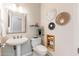 Elegant powder room features pedestal sink and contemporary wall art at 6135 E Campo Bello Dr, Scottsdale, AZ 85254