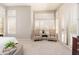 Bright bedroom featuring a cozy seating area bathed in natural light with large windows at 6135 E Campo Bello Dr, Scottsdale, AZ 85254