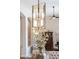 Close-up of a dining room chandelier with floral centerpiece at 6135 E Campo Bello Dr, Scottsdale, AZ 85254
