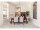 Dining area featuring a stylish chandelier and view into the kitchen at 6135 E Campo Bello Dr, Scottsdale, AZ 85254