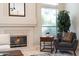 Close up of the tile fireplace with side table and chair in the living room at 6135 E Campo Bello Dr, Scottsdale, AZ 85254