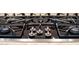 Close up of the stainless steel and black gas range in the kitchen at 6135 E Campo Bello Dr, Scottsdale, AZ 85254