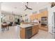 Spacious kitchen featuring granite countertops, stainless steel appliances, and eat-in island with sink at 6135 E Campo Bello Dr, Scottsdale, AZ 85254
