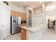 Contemporary kitchen showcases stainless steel fridge, granite island with sink, and ample cabinet space at 6135 E Campo Bello Dr, Scottsdale, AZ 85254
