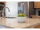 Close-up shot of kitchen island with granite countertop, undermount sink, and stainless steel appliances at 6135 E Campo Bello Dr, Scottsdale, AZ 85254
