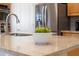 Close up of marble-style kitchen island countertop with a bowl of green apples at 6135 E Campo Bello Dr, Scottsdale, AZ 85254