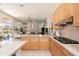 Bright, open kitchen with wooden cabinets, stainless steel appliances, and seamless view to the living room at 6135 E Campo Bello Dr, Scottsdale, AZ 85254