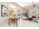Bright living room featuring a dining area, fireplace, tile floors, and backyard access at 6135 E Campo Bello Dr, Scottsdale, AZ 85254