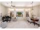 Open-concept living and dining area with piano, large windows, and view to the backyard pool at 6135 E Campo Bello Dr, Scottsdale, AZ 85254