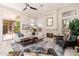 Cozy living room with a fireplace, large windows, and comfortable seating at 6135 E Campo Bello Dr, Scottsdale, AZ 85254