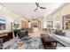 Open-concept living room and kitchen area with modern decor, tile flooring, and ample natural light at 6135 E Campo Bello Dr, Scottsdale, AZ 85254