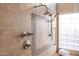 Detail of a tiled shower featuring a seat, shower fixture, and a glass block window at 6135 E Campo Bello Dr, Scottsdale, AZ 85254