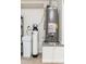 Water heater and water softener in the utility room with shelving at 6135 E Campo Bello Dr, Scottsdale, AZ 85254