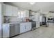 Modern kitchen with stainless steel appliances, ample counter space, and white cabinetry at 618 N Stapley Dr, Mesa, AZ 85203