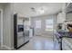 Bright kitchen featuring stainless steel refrigerator and modern appliances at 618 N Stapley Dr, Mesa, AZ 85203