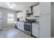 Kitchen with white cabinets, stainless steel appliances, and granite countertops at 618 N Stapley Dr, Mesa, AZ 85203