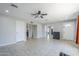Open-concept living room with bright, neutral paint, tile floors, and a ceiling fan at 618 N Stapley Dr, Mesa, AZ 85203