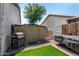 Backyard area with a grill, shed, and artificial turf at 630 E Racine Pl, Casa Grande, AZ 85122