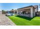 Backyard featuring artificial grass, a covered patio, and an above-ground pool perfect for outdoor entertainment at 630 E Racine Pl, Casa Grande, AZ 85122