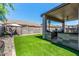 Spacious backyard with artificial turf, patio with lounge furniture, and block wall at 630 E Racine Pl, Casa Grande, AZ 85122