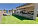 Spacious backyard with artificial turf, patio with lounge furniture, and block wall at 630 E Racine Pl, Casa Grande, AZ 85122