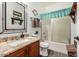Bathroom boasts a granite countertop, wood cabinets, and a shower-tub combo with a stylish glass door at 630 E Racine Pl, Casa Grande, AZ 85122