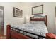 Bedroom featuring wood floors, cozy bedding, and a decorative wall art, creating a relaxing atmosphere at 630 E Racine Pl, Casa Grande, AZ 85122