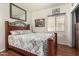 Bedroom featuring wood floors, cozy bedding, and a decorative wall art, creating a relaxing atmosphere at 630 E Racine Pl, Casa Grande, AZ 85122