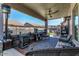 Relaxing covered patio featuring a ceiling fan, comfortable seating, and outdoor décor at 630 E Racine Pl, Casa Grande, AZ 85122