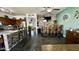 View of the dining area with stone bar, wood bar seating, and brick accent wall and a view to the Kitchen at 630 E Racine Pl, Casa Grande, AZ 85122
