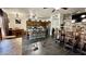 Open floor plan showcasing dining area connected to kitchen with tile flooring and brick accent wall at 630 E Racine Pl, Casa Grande, AZ 85122