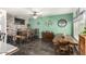 Cozy dining area with brick accent wall, tile floors, and rustic wood furnishings under a ceiling fan at 630 E Racine Pl, Casa Grande, AZ 85122