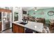 Kitchen island with granite counters, sink, and view of dining area with bar and table seating at 630 E Racine Pl, Casa Grande, AZ 85122