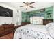 Primary bedroom with wood floors, plenty of natural light, rustic furniture, and view to back yard at 630 E Racine Pl, Casa Grande, AZ 85122