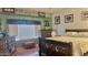 Bright primary bedroom with natural light, wood floors, rustic furniture, and decorative artwork at 630 E Racine Pl, Casa Grande, AZ 85122