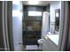 Bathroom featuring tiled walls, a walk-in shower, and a white vanity, offering a clean and functional space at 6725 W Cypress St, Phoenix, AZ 85035