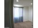 Cozy bedroom with neutral carpet and walls, featuring a window with patterned curtains for a comfortable space at 6725 W Cypress St, Phoenix, AZ 85035