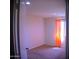 Bedroom featuring neutral carpet, a bright window with curtains, and a minimalist feel for relaxation at 6725 W Cypress St, Phoenix, AZ 85035