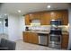 Galley kitchen features stainless steel appliances, ample cabinet space and tile flooring at 6725 W Cypress St, Phoenix, AZ 85035
